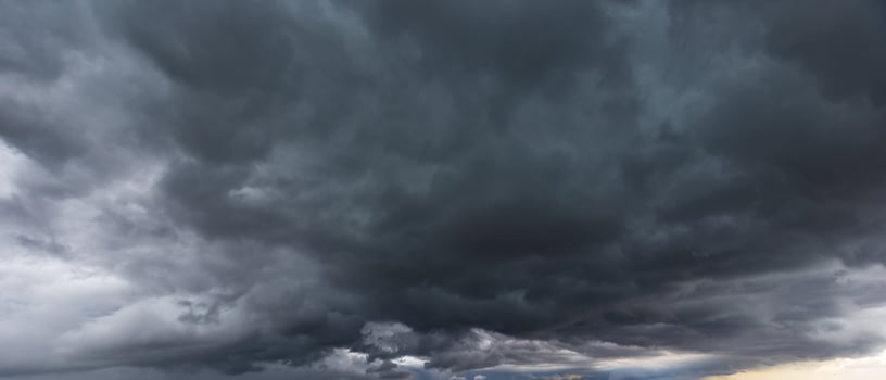 dark sky with heavy clouds converging and a violent storm before the rain.Bad or night weather sky and environment. carbon dioxide emissions, greenhouse effect, global warming, climate change photo
