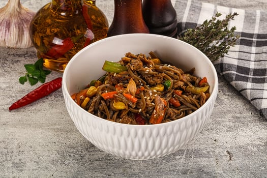 A bowl of noodles with vegetables and garlic photo
