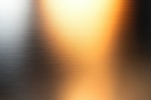 Metallic gradient texture with warm and cool tones, showcasing a brushed metal effect. photo
