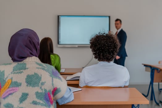 A university teacher using a smart board to explain a lesson in the classroom. photo