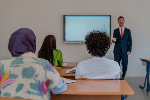 A university lecturer using a smart board to explain a lesson in the classroom. photo