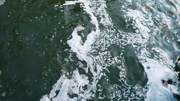 A stunning closeup view of a foamy water surface beautifully showcasing natures inherent beauty and fluid motion photo