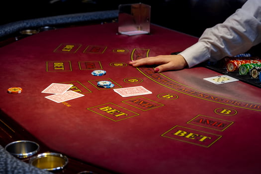 A person playing blackjack at a casino table photo