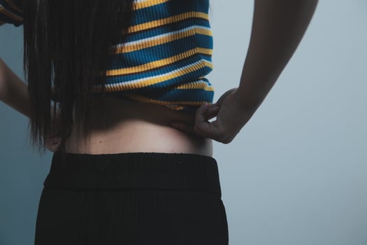 A woman with her hands on her stomach photo