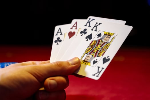 A person holding four cards in their hand photo
