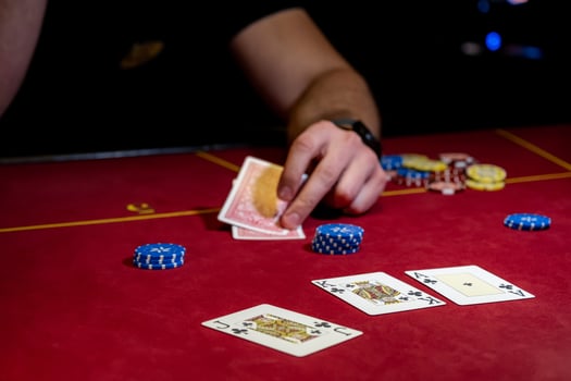 A man is playing poker with cards and chips photo