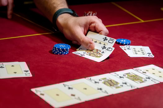 A person playing poker with cards and chips photo