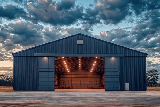 Large industrial hangar with open doors at dusk photo