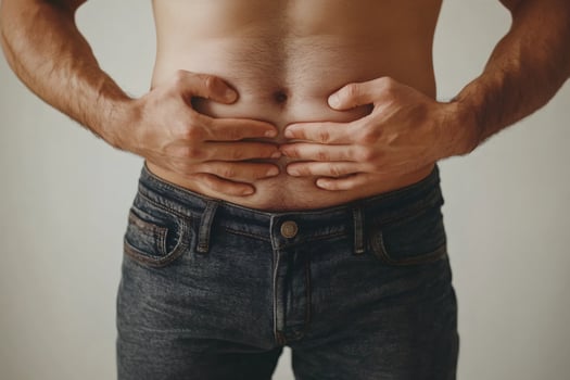 Man suffering from abdominal pain holding his belly photo