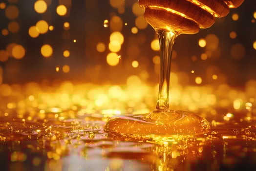Golden honey drizzling with warm glow photo