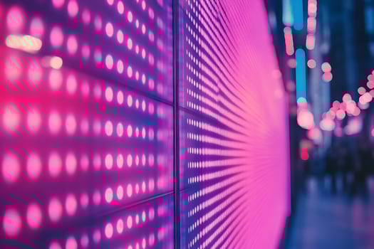 A pink neon light is shining on a wall photo