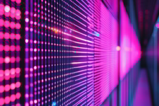A row of pink lights in a data center photo