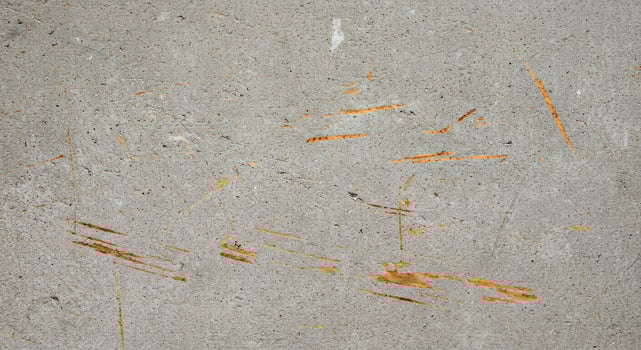 A concrete wall with orange paint on it photo