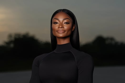 Confident woman poses with serene sunset backdrop showcasing natural beauty and elegance photo