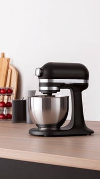 Black kitchen mixer on a wooden countertop with various kitchen utensils in a cozy, modern kitchen setting photo