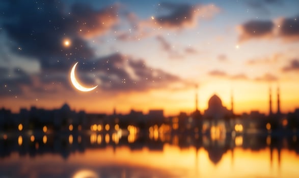 Crescent moon over city skyline at sunset photo