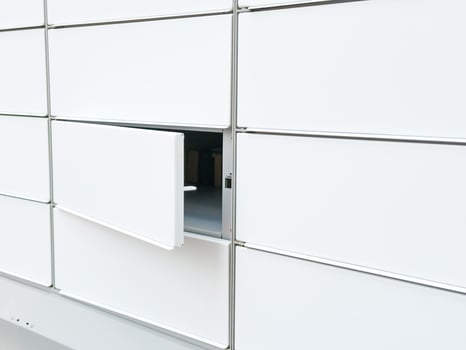 Open locker in a modern white parcel locker system for delivery and storage photo