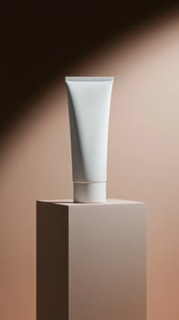 Elegant white tube of cream displayed on a minimal pedestal against a softly lit backdrop in an artistic setting photo