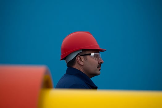Worker in safety gear monitors operations at a construction site, showcasing safety measures and focus on responsibility photo
