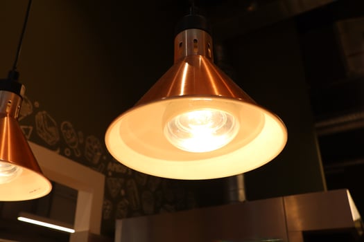 A Stylish Copper Pendant Light Fixture Perfectly Accentuates the Modern Kitchen Aesthetic photo