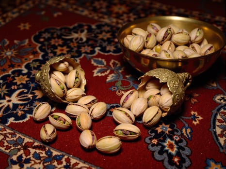 Pistachios in a bowl on a rug photo