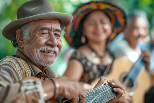 An old man playing a guitar with other people photo