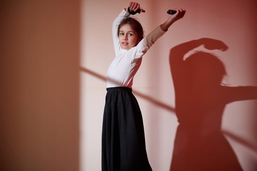 Young Girl Performing A Dance Routine Highlighted by Artistic Lighting photo