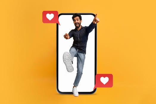 A joyful individual interacts with their smartphone, expressing excitement about social media messaging. The vibrant backdrop highlights the themes of love and connection, perfect for dating. photo