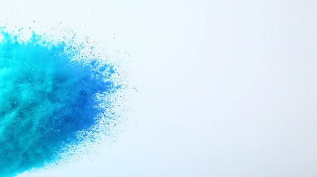 Vibrant blue powder explosion against a white background, conveying creativity and energy photo