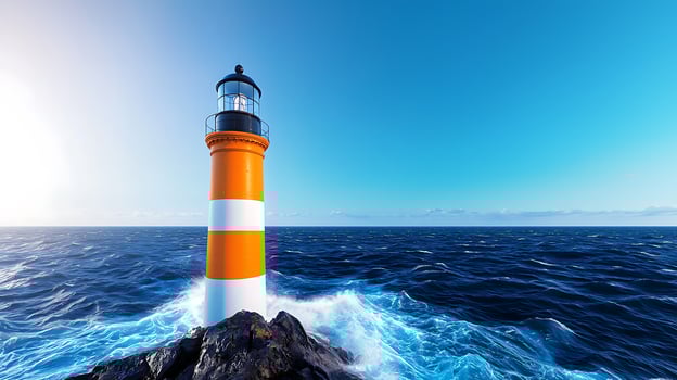 Vibrant lighthouse standing on rocky coast with waves crashing under a clear blue sky photo
