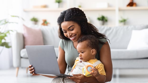 Happy Mother And Her Little Infant Son Using Laptop Computer At Home, Smiling African American Mom Showing Cartoons To Toddler Child While Relaxing On Floor In Living Room Together, Free Space photo