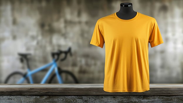 Yellow T-shirt displayed on a mannequin with a blurred bicycle in the background, showcasing leisure wear photo
