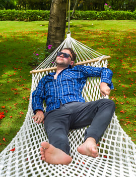 Young man freelancer resting on hammock photo