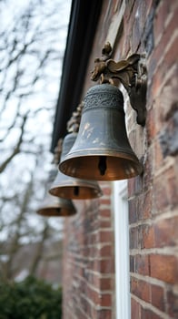 Three bells hanging on a brick wall, ringing for celebration photo