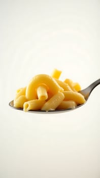 Closeup of a spoonful of macaroni pasta against a neutral background photo