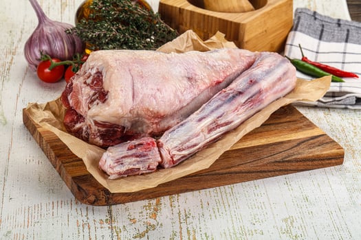 Raw meat on a cutting board with vegetables and spices photo