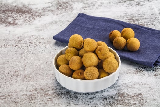 A bowl of olives and a napkin on a table photo
