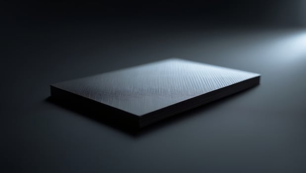 Minimalist black surface with soft light revealing geometric texture in a calm studio setting photo