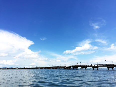 A pier with a bridge over water photo