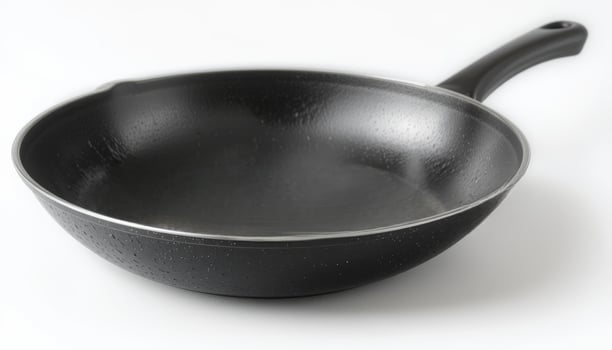 A sleek black frying pan with a smooth, non-stick surface, symbolizing modern cookware, suitable for culinary promotions, cooking shows, or kitchen supplies advertising. photo