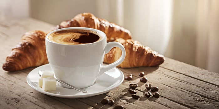 Delicious coffee and croissant breakfast scene on rustic wooden table photo