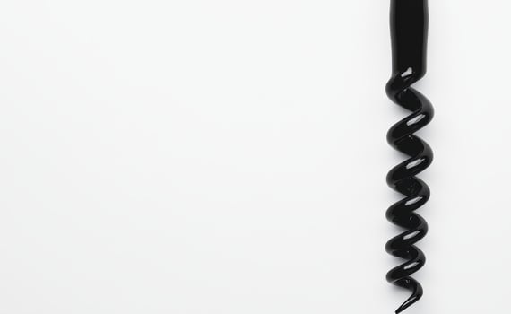 Spiral corkscrew tool on a plain background photo