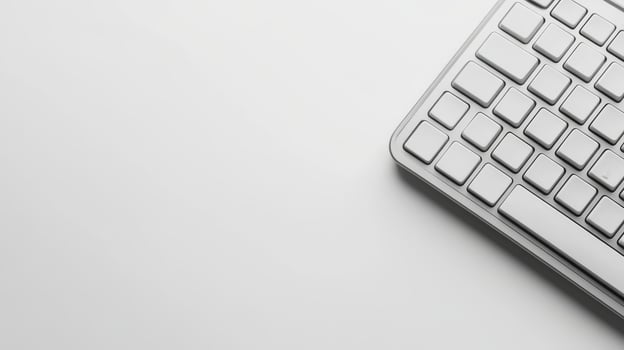 Minimalist gray keyboard placed on a light surface in modern workspace photo