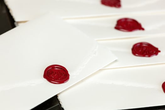 Sealing wax securing important invitation on parchment paper photo
