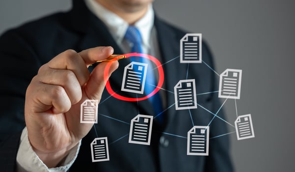 The businessman circles the required document in red. Importance, correction approvals. Urgent paperwork, or contract reviews. photo