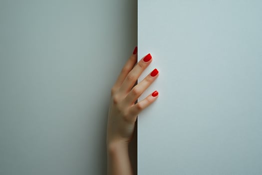 A woman's hand with red nails elegantly touches a white wall. Generated by artificial intelligence photo