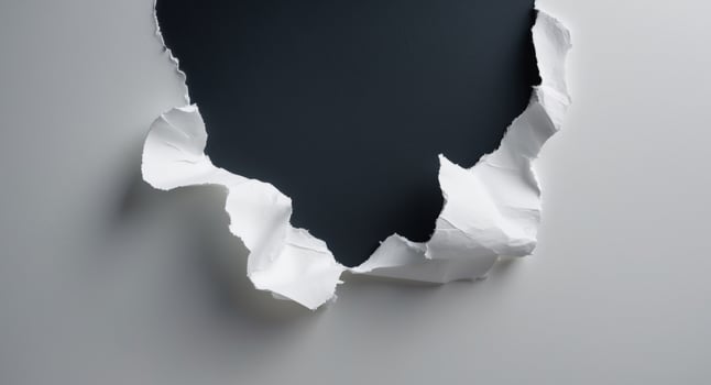A hole in a wall with a black hole photo