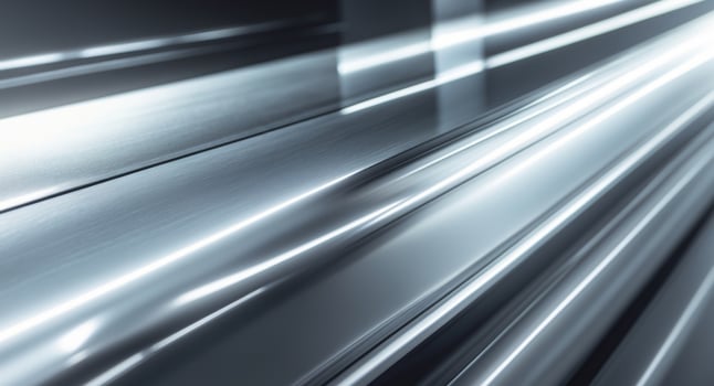 Shiny metallic surface with light beams creating a gradient effect of dark and bright areas photo