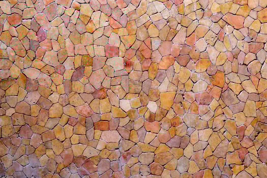 Tile pieces are arranged like a mosaic on the wall. Abstract background of wall texture. photo