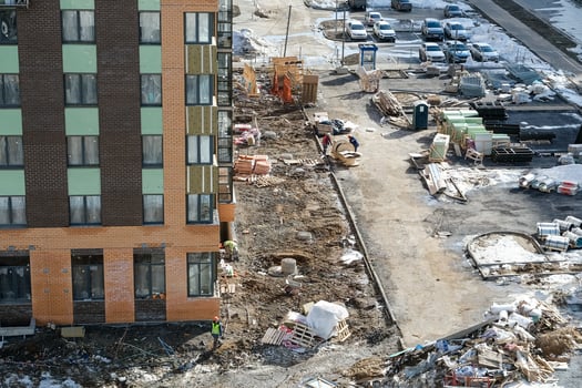 Construction site with a large building and a parking lot photo